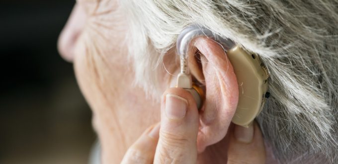 Elderly woman wearing a hearing aid