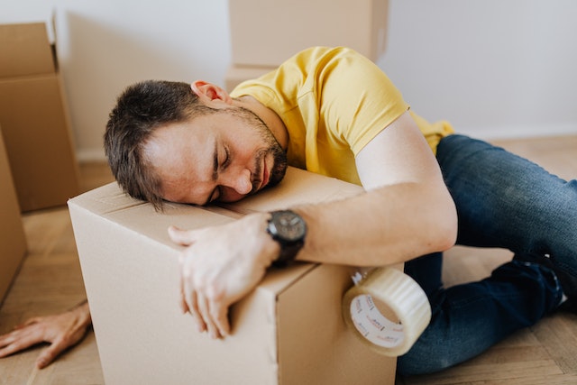 a man sleeping on a moving box