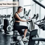 Wide-angle view of a modern commercial gym facility in the United States, showcasing a clean layout, organized equipment, and an inviting atmosphere for fitness enthusiasts.