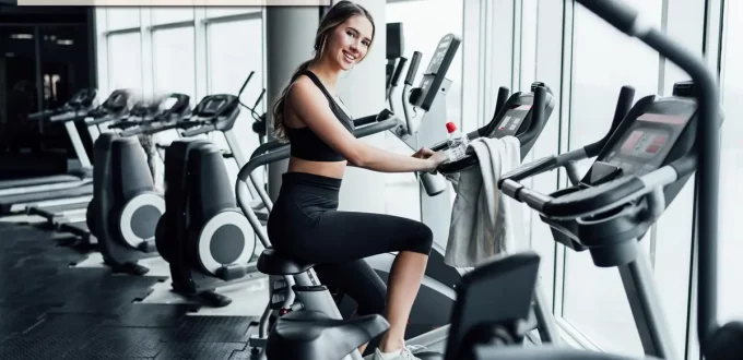 Wide-angle view of a modern commercial gym facility in the United States, showcasing a clean layout, organized equipment, and an inviting atmosphere for fitness enthusiasts.