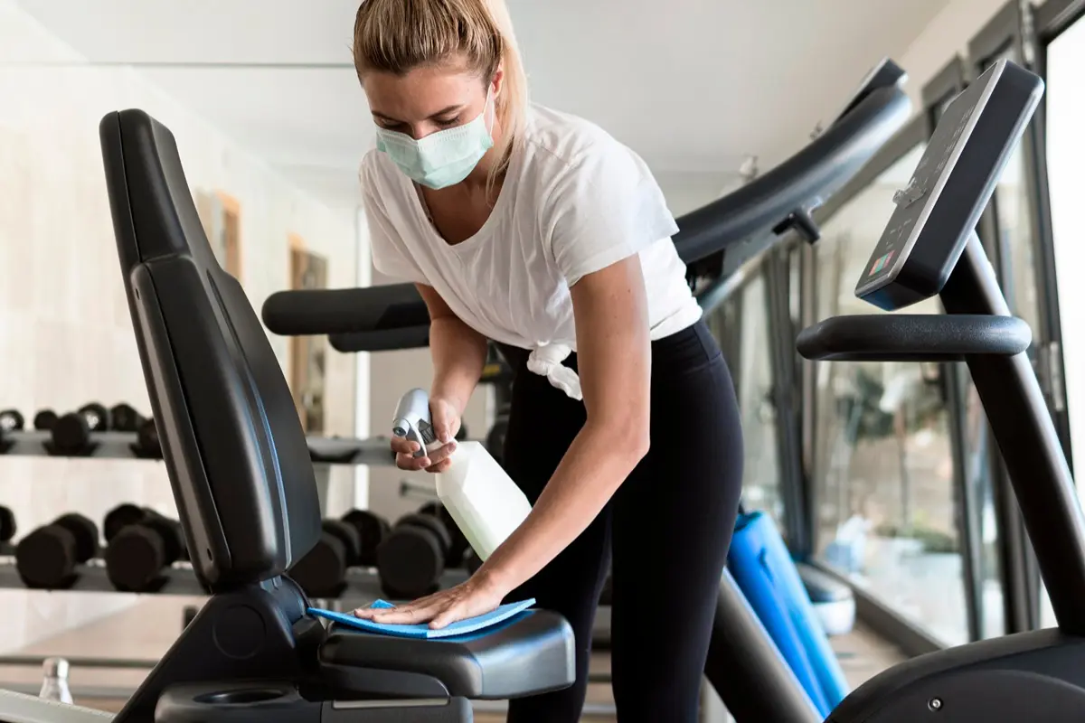 Close-up of well-maintained gym equipment including professional-grade squat racks and organized dumbbells, demonstrating high facility standards for strength training.