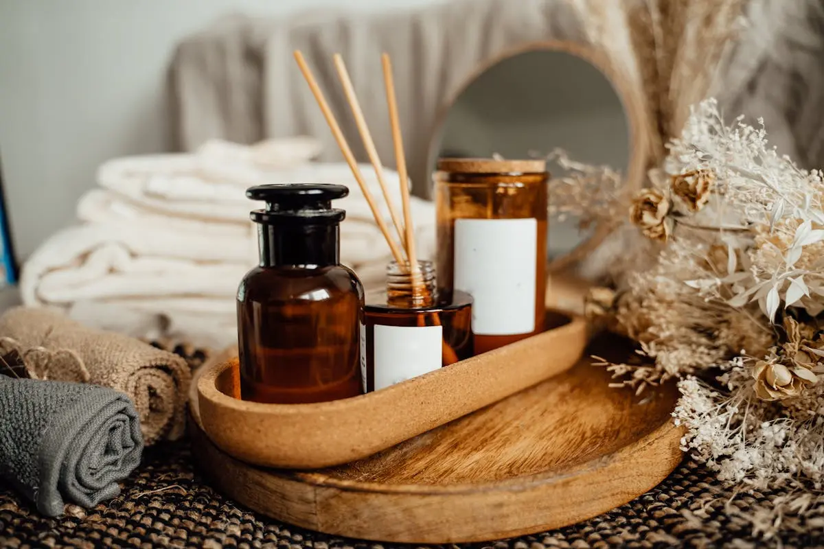 Luxury spa essentials including essential oils and white robes prepared for an at-home restorative bachelorette sanctuary.