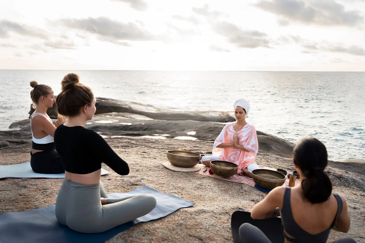 A bridal party participating in a private sunrise yoga session at a restorative wellness retreat.